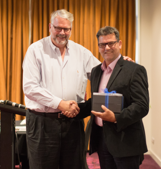 Peter Wade receiving a gift from Greg Whitby. Peter Wade receiving a gift from Greg Whitby.